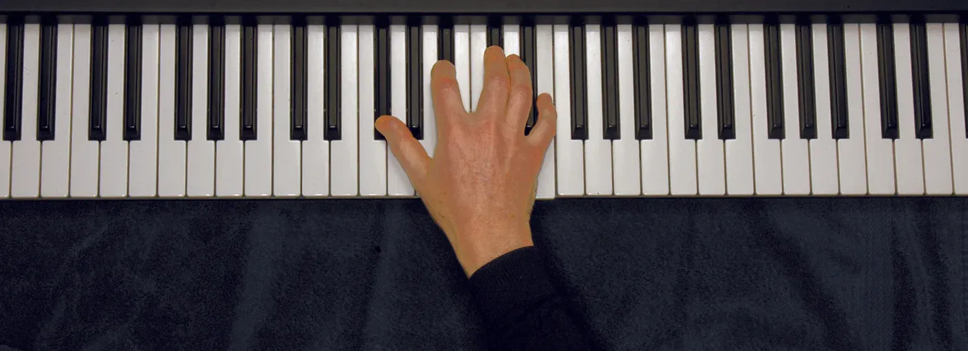 Gb7 chord played on a piano — hand position on the keys